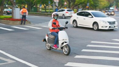 Driver on electric scooter in Asia