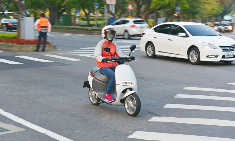 Driver on electric scooter in Asia