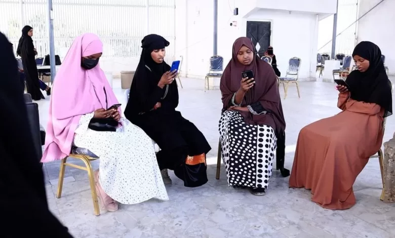 Women learning to read with app in Somalia