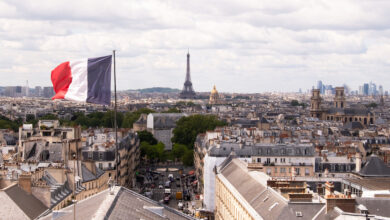 France, Paris, Cityscape with french flag and Eiffel tower in background