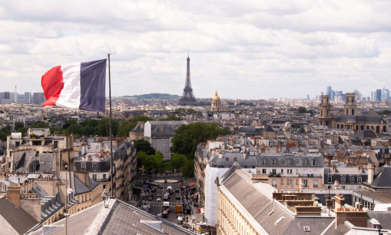 France, Paris, Cityscape with french flag and Eiffel tower in background