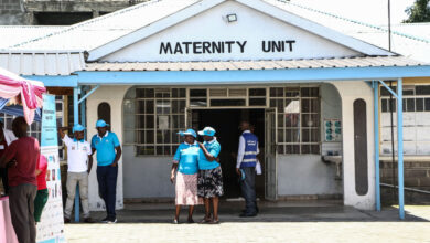 People stand in front of a maternity unit during the