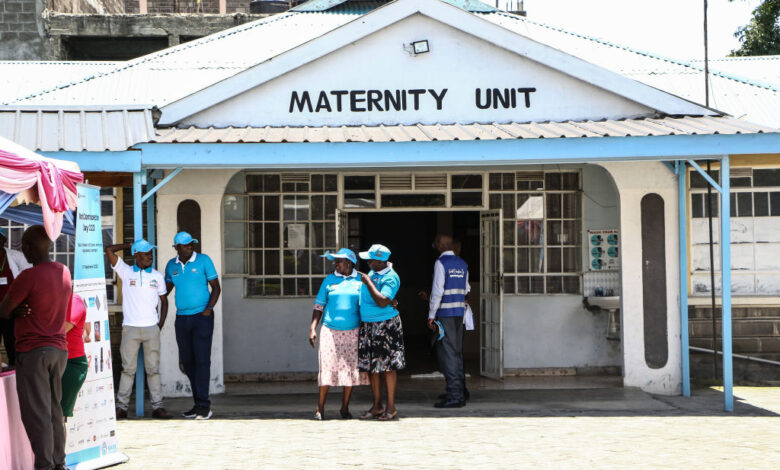 People stand in front of a maternity unit during the