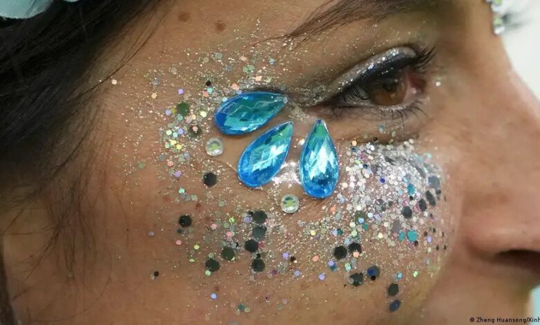 Face with blue glitter around the eyes, close up