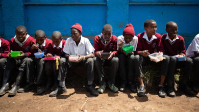 Schoolkids eating provided lunch at school in Nairobi