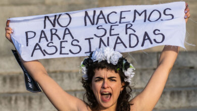 Activist of feminist group FEMEN holds a banner