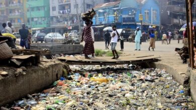Drainage channel blocked with bottles and styrofoam food containers in Lagos