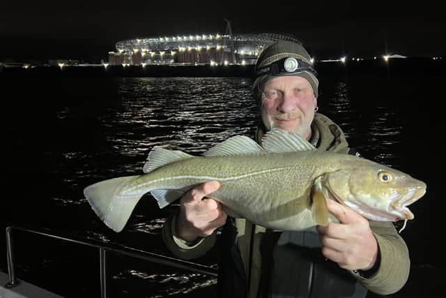 Tony Shep with a cod he caught near the Everton Stadium, a type of fish that had been caught far less in 2023