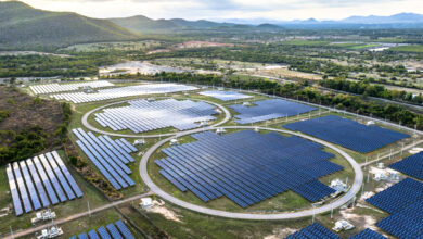 Aerial of solar panel farm in rural area.
