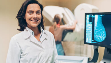 Smiling female doctor in mammography exam room