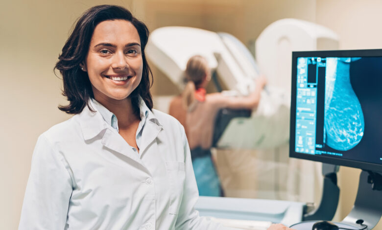 Smiling female doctor in mammography exam room