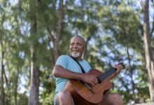 An older inhabitant of Mauritius playing guitar