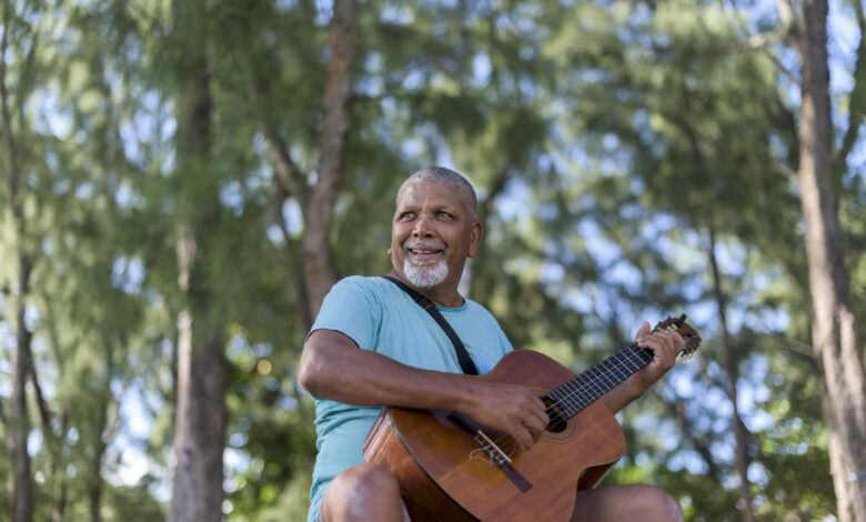 An older inhabitant of Mauritius playing guitar
