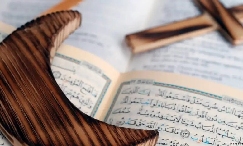 Wooden half moon and cross on Koran