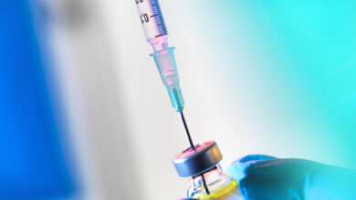 Syringe inserted into a vaccine vial