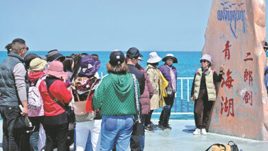 Tourist pose for pictures at Qinghai Lake China