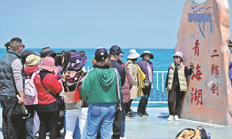 Tourist pose for pictures at Qinghai Lake China