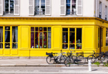 Yellow building facade and bikes in Paris, France