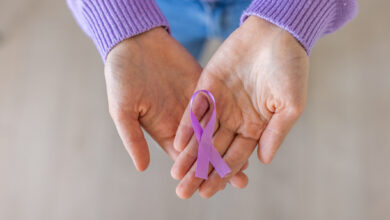 Unrecognizable woman holding in her hands purple ribbon