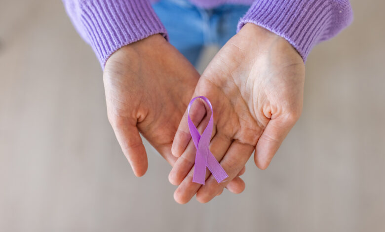 Unrecognizable woman holding in her hands purple ribbon