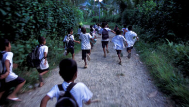 Children running in village lane
