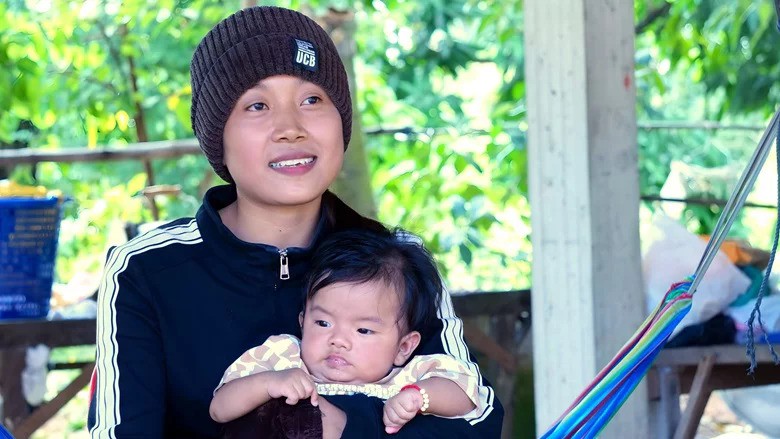 Choeum Sreyrath, her baby in arms, talks about her role as a Village Health Support Group (VHSG) in Kampong Chhnang province