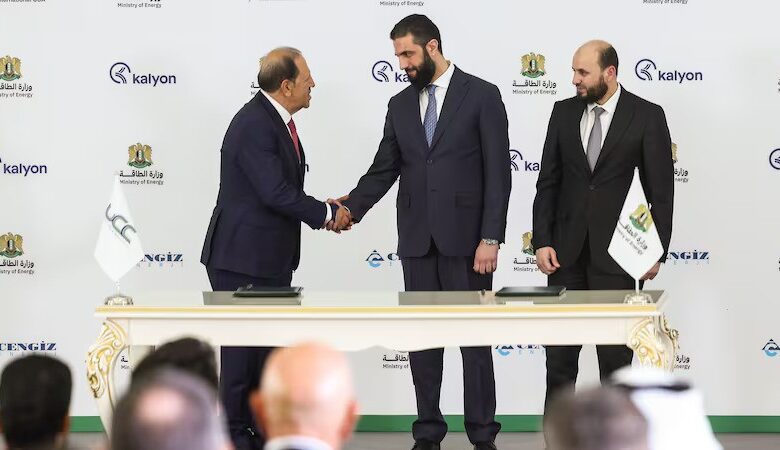 Syria's President Ahmad Al Shara, centre, shakes hands with Orhan Cemal Kalyoncu, chairman of Kalyon Holding, as Syrian Minister of Energy Mohammad Al Bashir watches