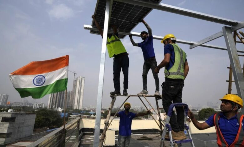 Workers of Solar Square place a panel on the rooftop of a residence in Gurugram on the outskirts of New Delhi, India, Feb. 20, 2024