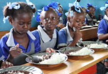 Haiti. Students eat a hot meal in their classroom in the primary school Baptiste Salem in Dondon