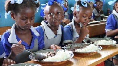 Haiti. Students eat a hot meal in their classroom in the primary school Baptiste Salem in Dondon