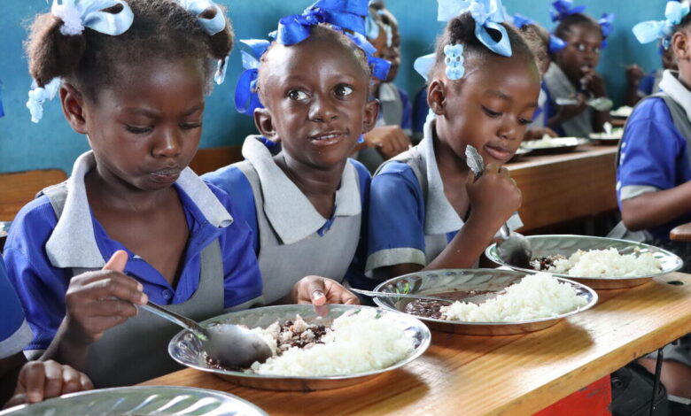 Haiti. Students eat a hot meal in their classroom in the primary school Baptiste Salem in Dondon