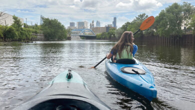 Krystyna Kurth paddles toward downtown on the Chicago River