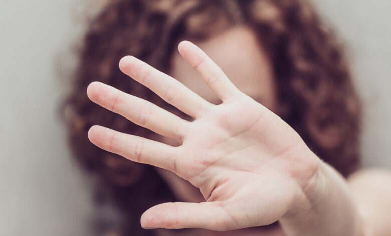 Woman makes stop gestures