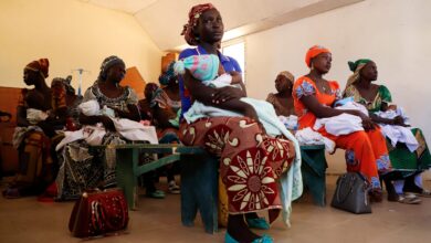 Mothers hold their children as they wait to be vaccinated against malaria, at the health center in Datcheka, Cameroon, on January 22, 2024.
