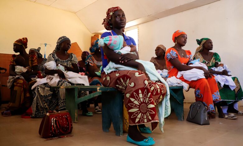 Mothers hold their children as they wait to be vaccinated against malaria, at the health center in Datcheka, Cameroon, on January 22, 2024.