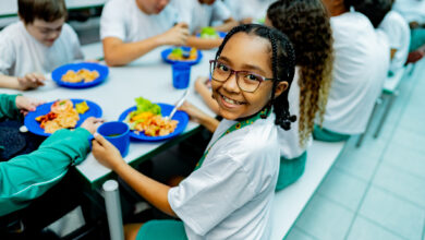 Portrait of a schoolgirl having lunch in the cafeteria at school