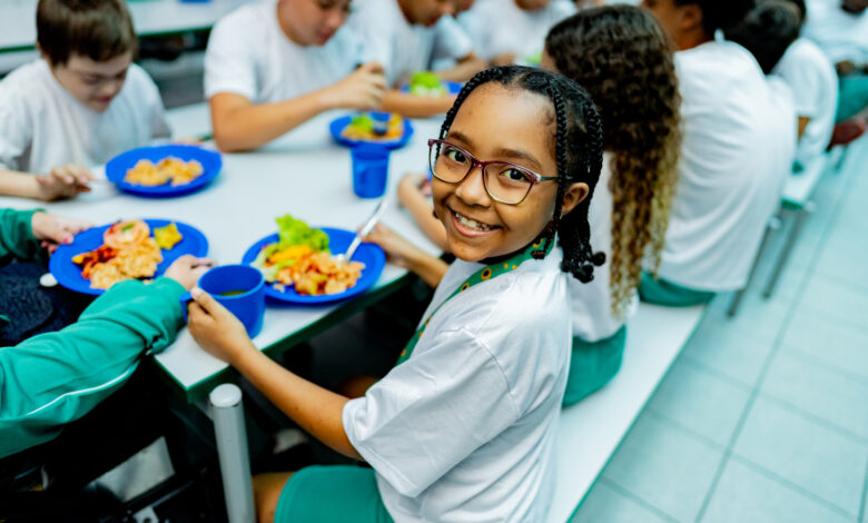 Portrait of a schoolgirl having lunch in the cafeteria at school