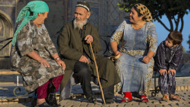 Pilgrims in front of the Ulugh Beg Madrasah in Samarkand
