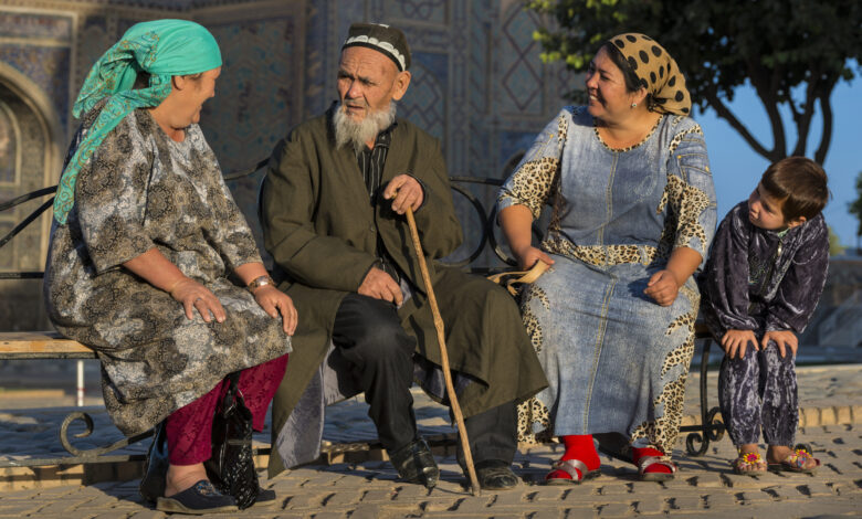 Pilgrims in front of the Ulugh Beg Madrasah in Samarkand