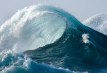 Large wave splashing in blue sea