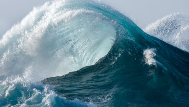 Large wave splashing in blue sea