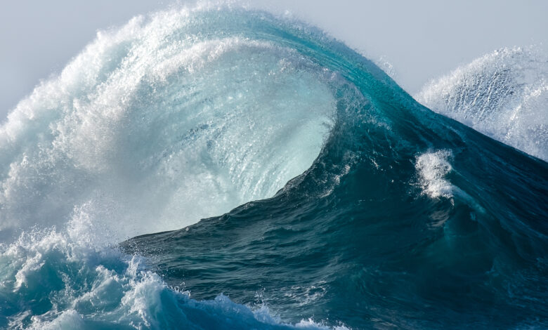 Large wave splashing in blue sea