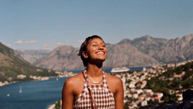 Happy woman enjoying sunlight on face during vacation