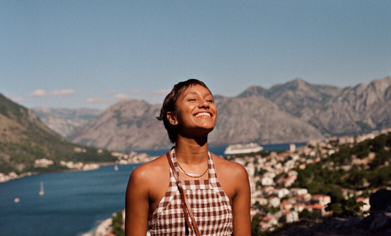 Happy woman enjoying sunlight on face during vacation