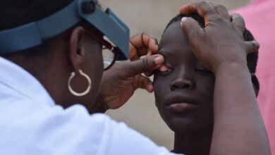 A young boy's eyes are examined for signs of trachoma during a Tropical Data Training in Senegal.
