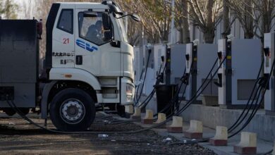 electric truck driver is charging his vehicle