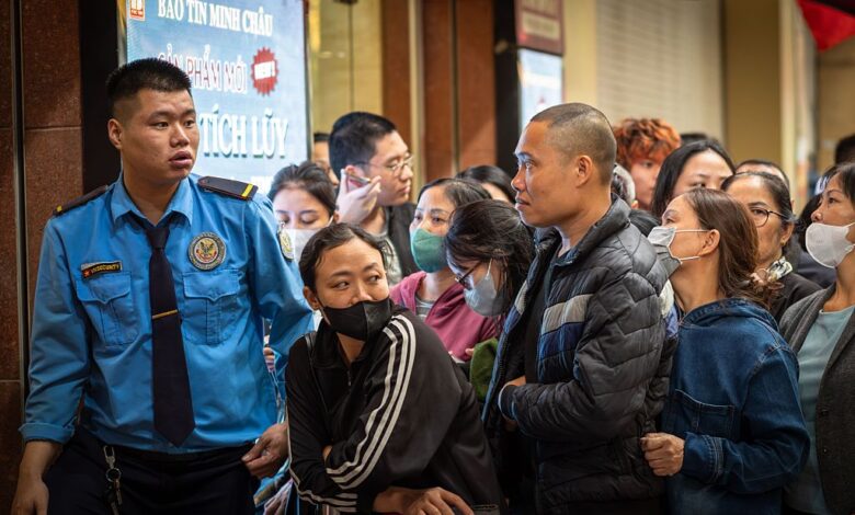 People crowd round to sell gold, Hanoi, Vietnam