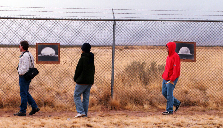 F366942 08: Tourists look at photographs of the first nuclear bomb test at the Trinity Site where the bomb was tested at 5:29:45 a.m. Mountain War Time on July 16, 1945 on the White Sands Missile Range, New Mexico, April 1, 2000. The 19 kiloton explosion not only led to a quick end to the war in the Pacific but also ushered the world into the atomic age.