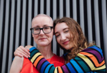 Portrait woman with cancer hugging her daughter