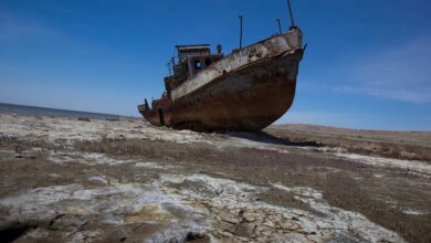 A fishing boat lies stranded on the desertified remains of the Aral Sea